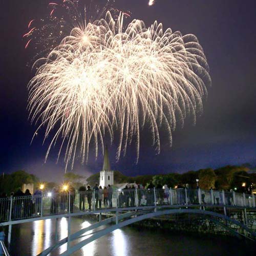 Crowd watching fireworks from bridge